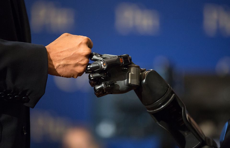 Human and artificial intelligencerobot fist bumping