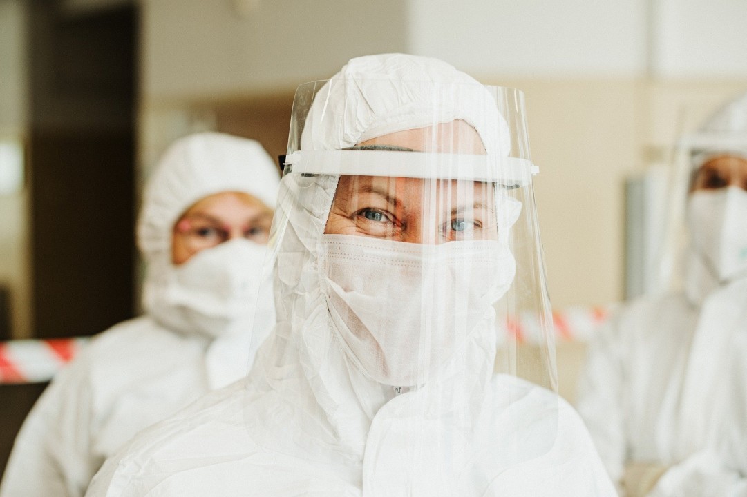 Front line workers in hazmat suits