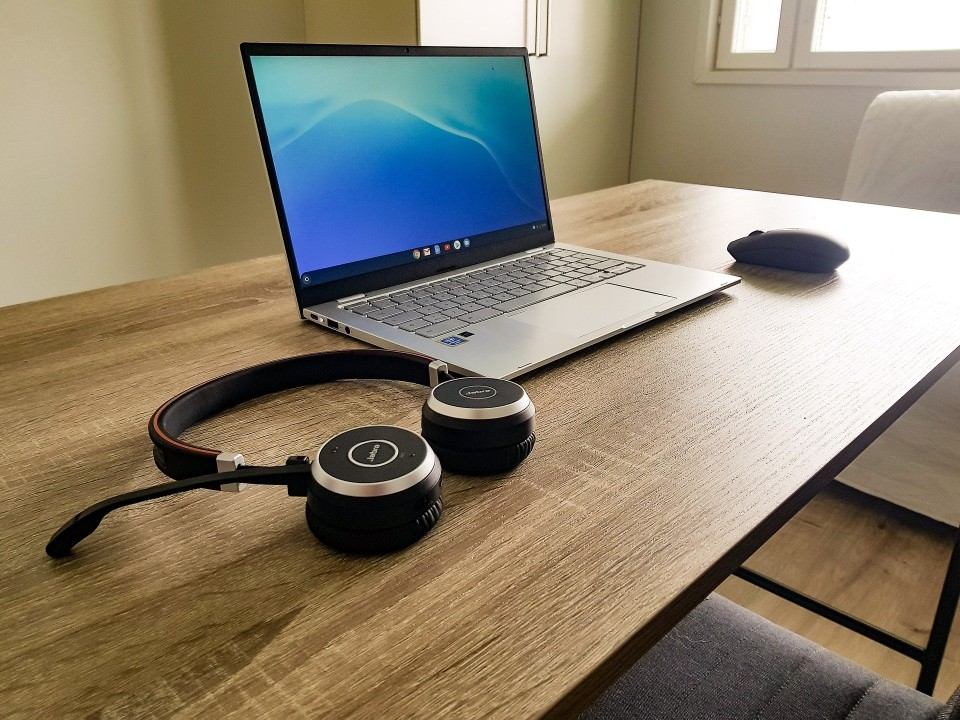 Remote work with laptop, computer mouse and headset on desk