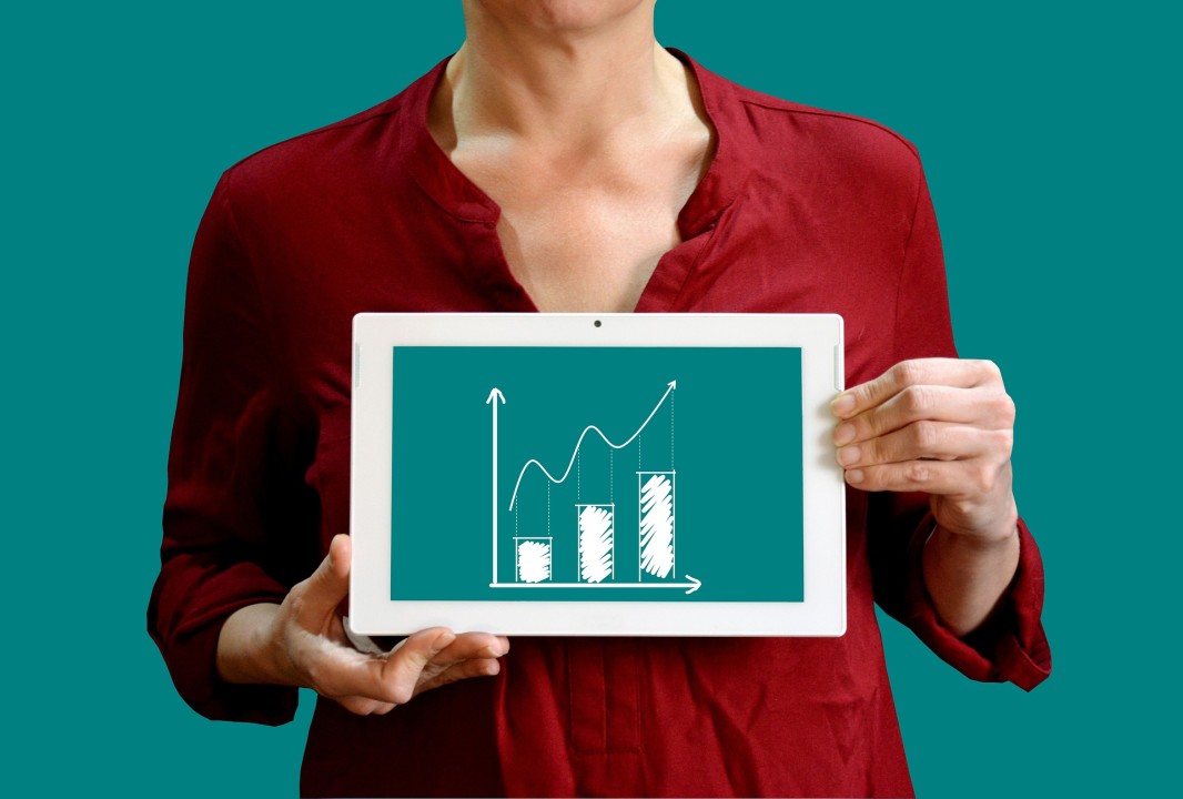 Women holding iPad with bar graph on it